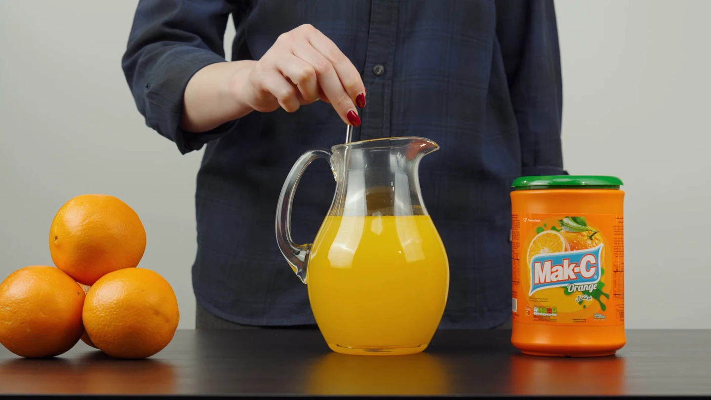 Mak-C drink crystals being prepared beside the branded pack