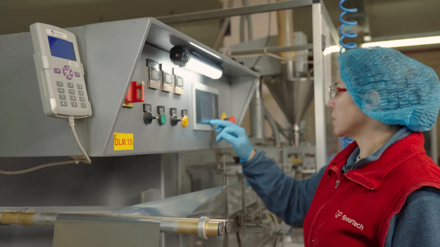 A FlavourTech operator working at production controls